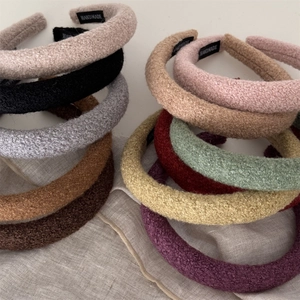 Macro shot showing soft wool textures and handmade tags of colorful sponge headbands