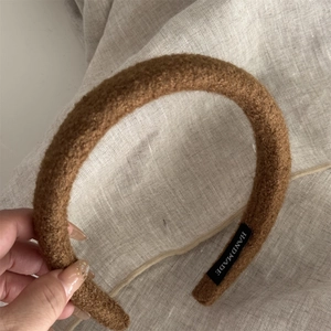 Detail view of a handmade brown plush sponge headband with high crown aesthetic