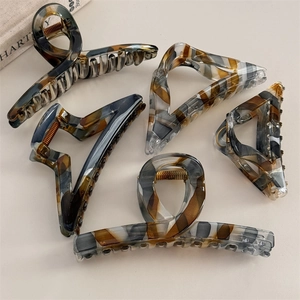 Macro view of five-piece tortoiseshell acetate hair claw set with marble patterns