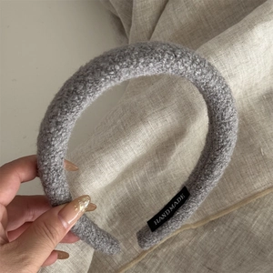Close-up of handmade grey plush headband showing soft wool-like texture and thick sponge padding