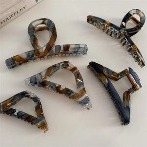Detailed set of five vintage marble texture acetate hair claws in various geometric shapes
