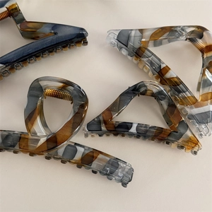 Minimalist tortoiseshell acetate claw clips in geometric shapes for long hair styling