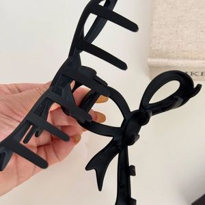 Matte black large bow hair claw clip made of resin for thick hair styling