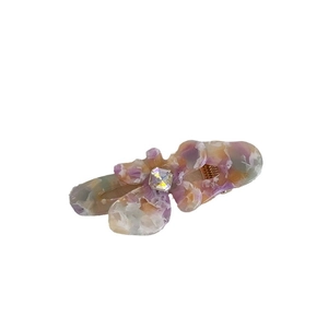 Elegant floral rhinestone hair clip featuring a purple and orange acetate tortoiseshell finish