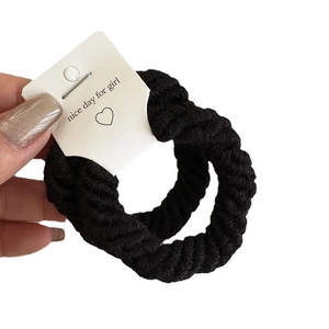 Thick black woven elastic hair tie with spiral texture and cute heart card packaging