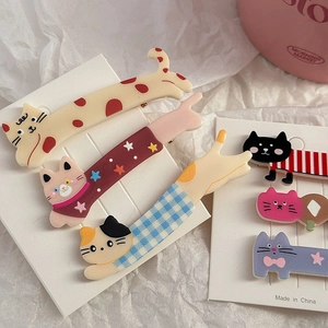 Detailed view of colorful cat-shaped acrylic hair clips with varied patterns on display card
