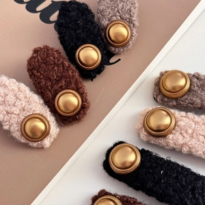 Faux shearling hair clips with vintage gold metal buttons in warm neutral colors