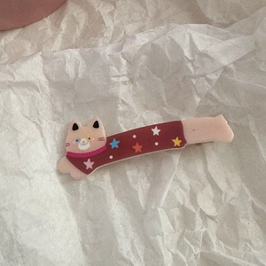 Close-up of cute acrylic cat hair clip with colorful stars and pink kitten head