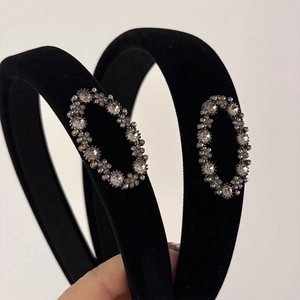 Detail of black velvet padded headband featuring sparkling oval rhinestone embellishments