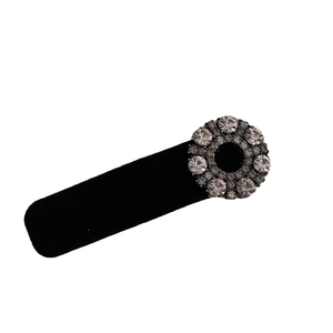 Vintage black velvet hair clip with circular rhinestone detail in elegant retro style