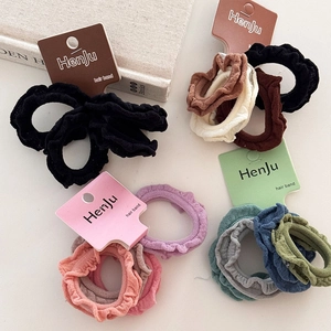 4-pack elastic ruffle hair scrunchies in assorted colors with ruffled fabric design