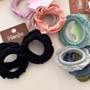 Set of 4 elastic knit hair scrunchies with wavy ruffle edges in assorted stylish colors