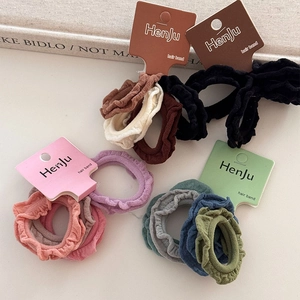 Detailed view of elastic ruffled hair bands in multiple colors with card packaging