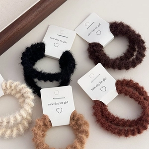 Set of minimalist fuzzy knit hair scrunchies in autumn colors displayed on cards