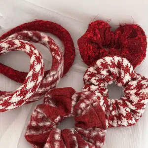 Detailed close-up of festive red and white tweed headbands and soft velvet hair scrunchies
