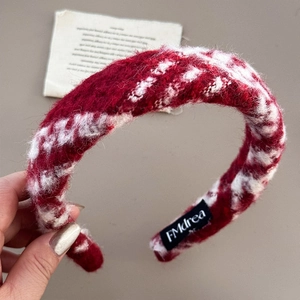 Close-up detail of the red and white checkered wool headband with soft fuzzy texture