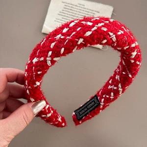 Close-up of red and white tweed headband texture with inner handmade label detail