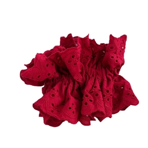 Vibrant red oversized lace scrunchie with detailed Broderie Anglaise embroidery design