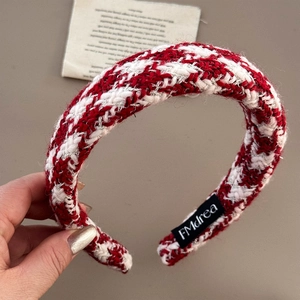 Close-up of red and white tweed headband with silver thread and thick sponge padding
