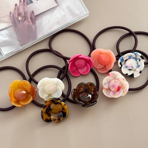 Set of 8 elegant acetate flower hair ties in diverse marble and tortoiseshell patterns