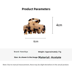 Detailed view of acetate hair claw with brown tortoise shell pattern and size markings