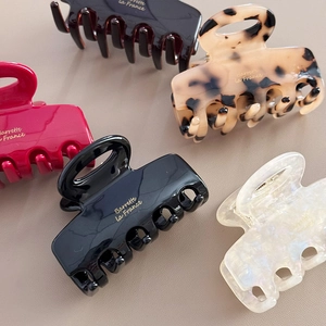 Chic acetate shark hair claw clips in assorted colors with gold lettering finish