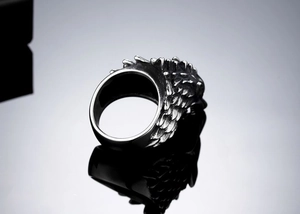Macro shot of punk wolf head ring showing detailed metal scales and feather texture