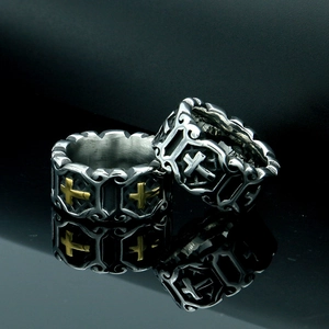 Detail of gothic cross rings in silver and gold-silver tones with hollow floral patterns