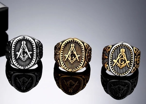 Macro view of Freemasonry square and compass symbols on stainless steel rings