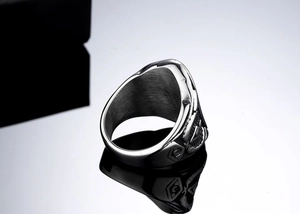 Macro side view showing the detailed eagle relief and geometric patterns on a steel ring