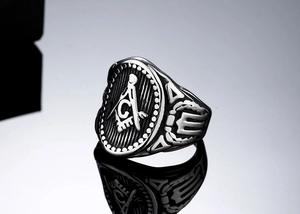 Macro detail of vintage Freemason Masonic ring showing the G compass and square engraving