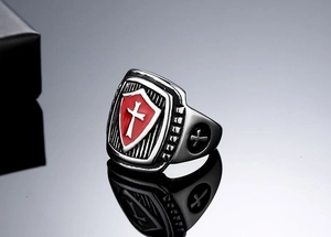 Detail view of crusader shield ring featuring red enamel cross and vintage steel finish
