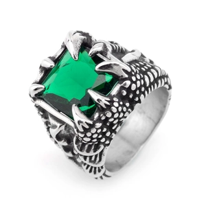 Detail of vintage steel dragon claw ring holding a square green gemstone on white background
