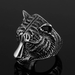 Macro shot of a vintage tiger head ring in oxidized stainless steel with deep textures