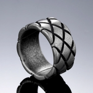 Macro shot of vintage silver titanium steel ring with engraved diamond pattern