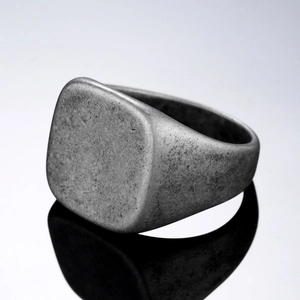 Vintage industrial square signet ring in matte titanium steel with elegant reflection