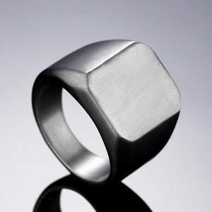 Macro view of minimalist square signet ring showing matte brushed titanium steel texture