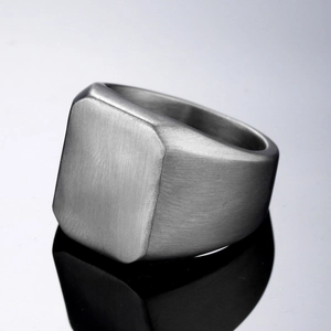 Macro view of matte brushed stainless steel signet ring with a minimalist square face