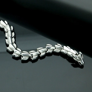 Detailed macro view of the dragon scale chain links and polished dragon head clasp