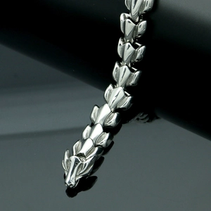 Close-up detail of dragon head clasp and interlocking steel link bone chain