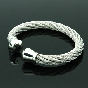 Detalle del brazalete abierto de cable de acero inoxidable trenzado estilo industrial