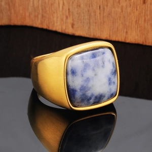 Macro shot of men's matte gold signet ring with a blue natural stone inlay detail
