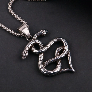 Detail of double snake heart pendant with intricate scales on a silver bead chain