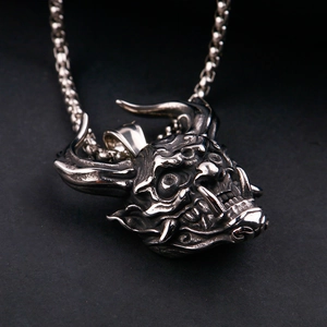 Macro detail of gothic bull demon pendant with sharp horns and vintage steel texture