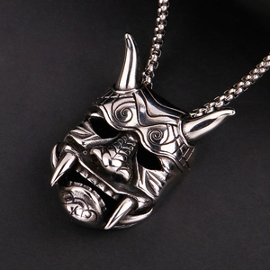 Macro detail of gothic skull pendant in vintage silver steel showing fine textures