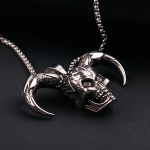 Detail of gothic devil skull pendant with bull horns and antique silver finish