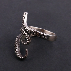Detailed close-up of a vintage silver octopus tentacle ring with suction cup textures