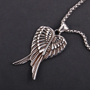 Close-up of silver steel wing pendant featuring detailed feather texture and box chain