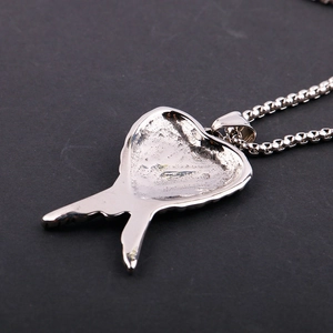 Silver stainless steel heart wing pendant necklace shown from the back perspective