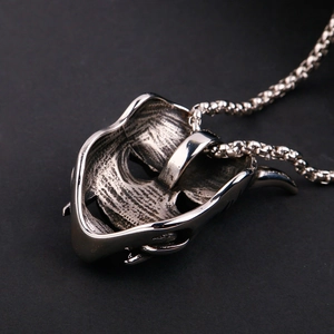 Macro shot of punk style steel skull pendant with vintage silver finish and box chain